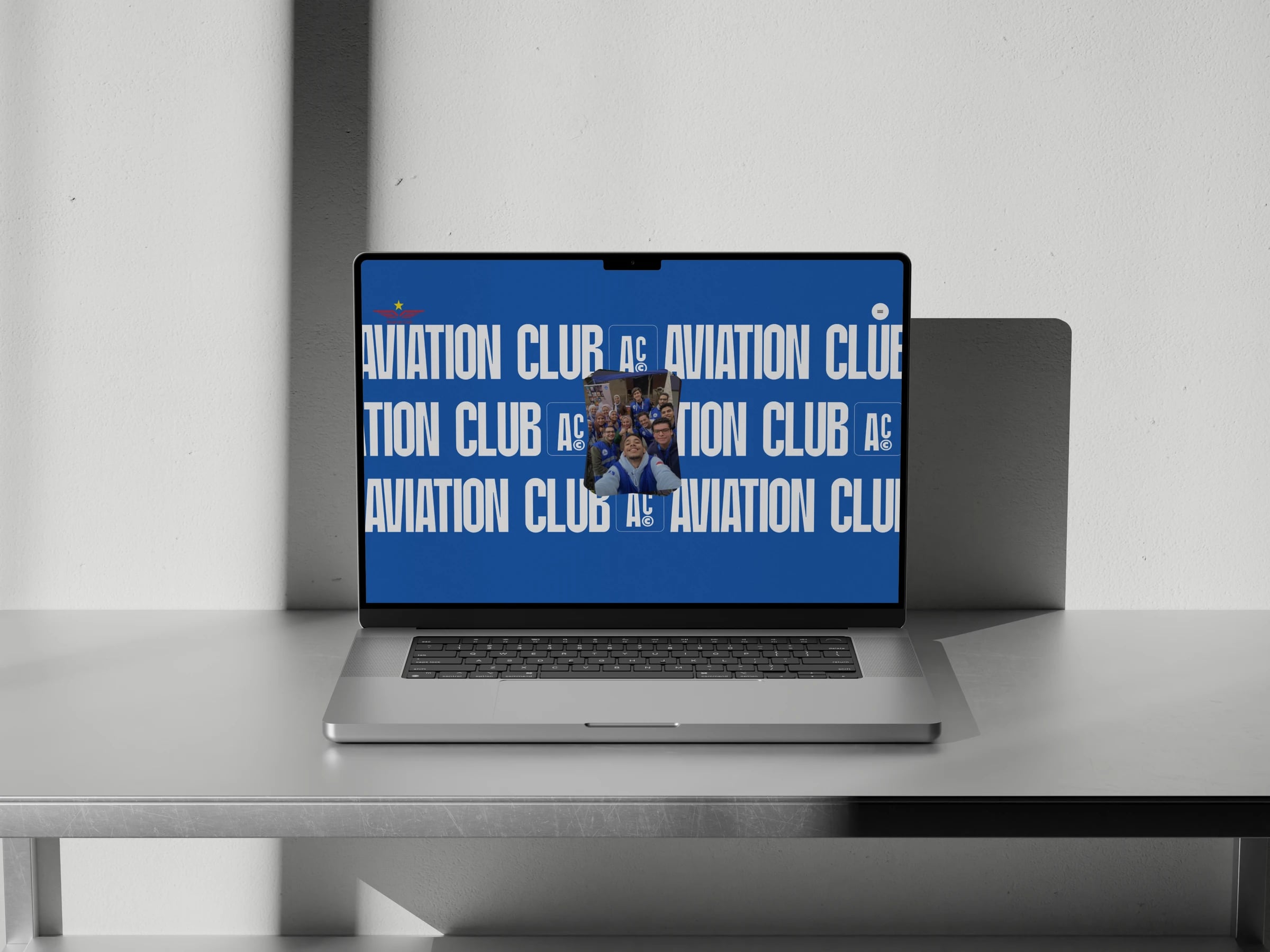 Aviation Club website: Laptop showing the 'Aviation Club' type marquee with a team selfie