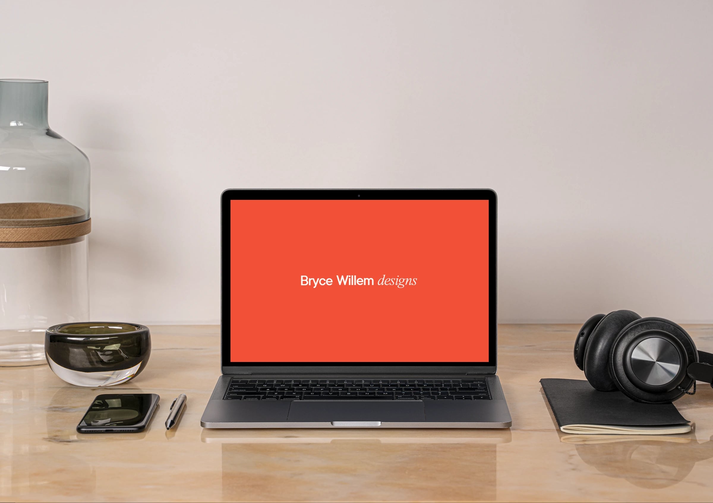 Bryce Willem website: Laptop on a desk showing the 'Bryce Willem designs' intro screen