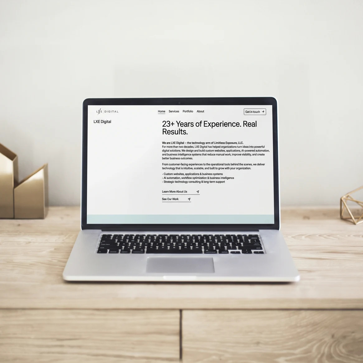 LXE Digital website: Laptop on a wooden desk showing the LXE Digital '23+ Years of Experience' section